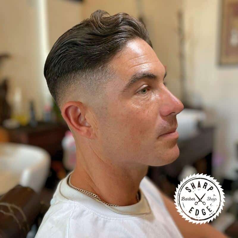 Barber creating a perfect fade for a client at Sharp Edge Barber